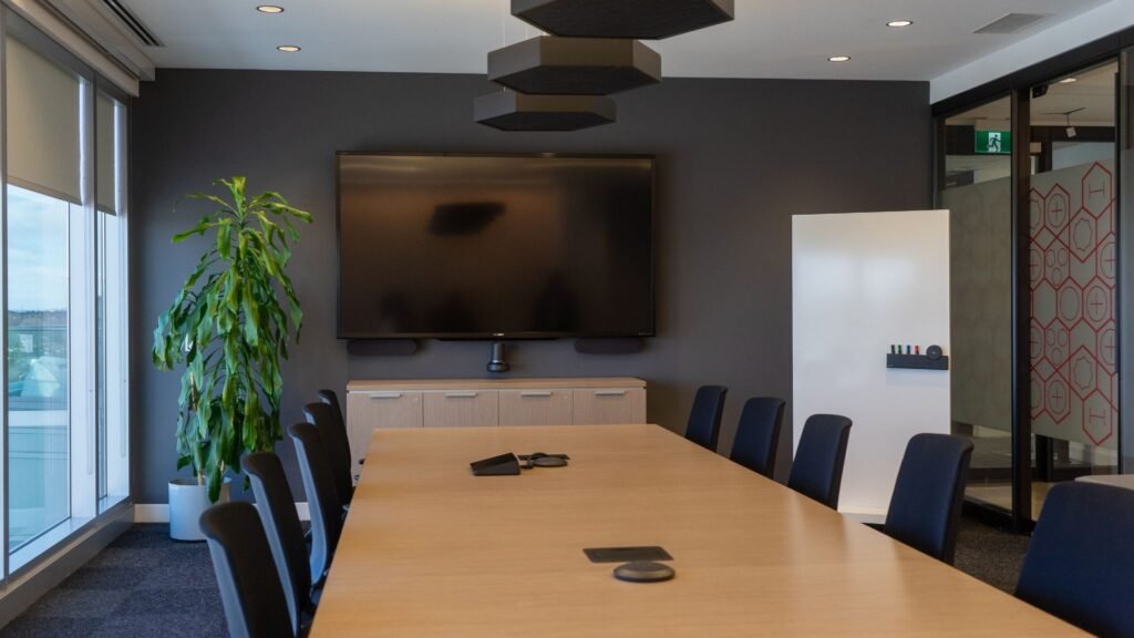 Modern boardroom design in Puerto Rico featuring integrated AV systems and executive seating.